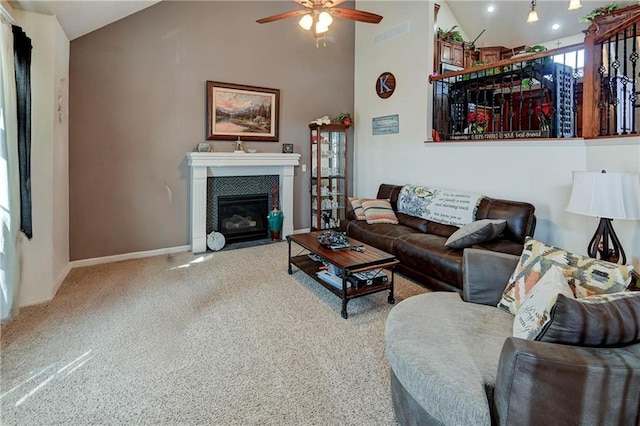 living area featuring visible vents, a fireplace with flush hearth, carpet flooring, high vaulted ceiling, and baseboards