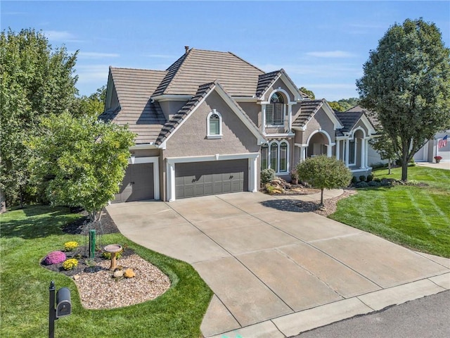 traditional home with an attached garage, a front lawn, concrete driveway, and stucco siding