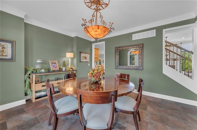 dining space featuring ornamental molding, visible vents, and baseboards