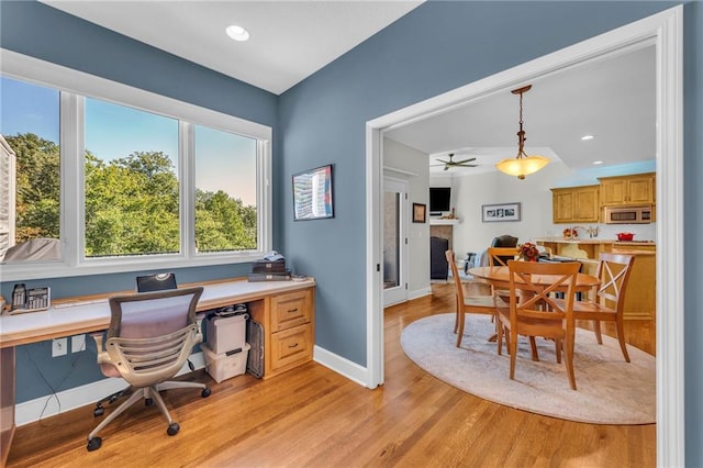 office with recessed lighting, light wood-type flooring, a fireplace, and baseboards