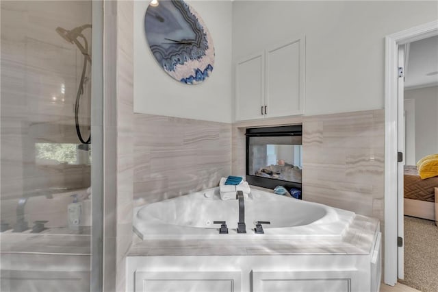 bathroom with walk in shower and a multi sided fireplace