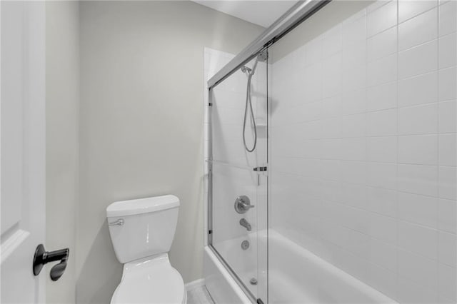 full bathroom with shower / bath combination with glass door and toilet