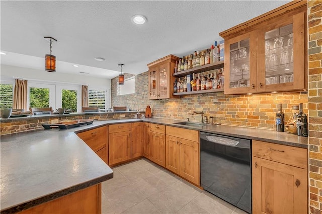 kitchen featuring decorative light fixtures, a sink, black dishwasher, decorative backsplash, and glass insert cabinets