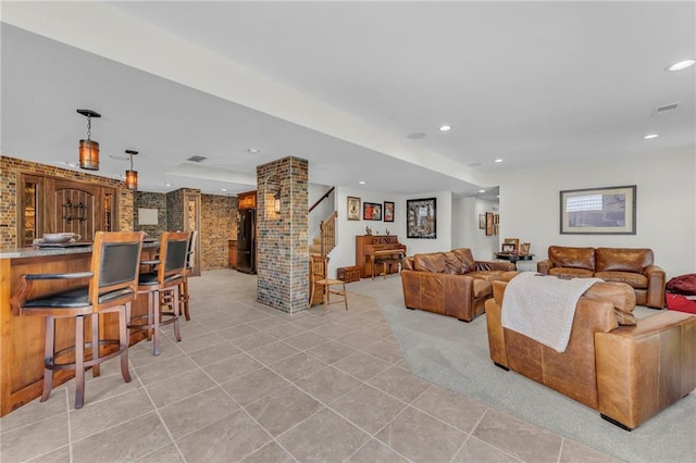 living room with light tile patterned floors, visible vents, light colored carpet, stairs, and recessed lighting