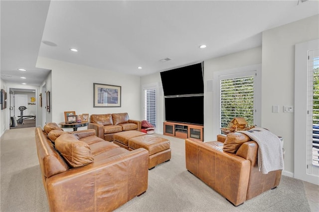 living area featuring light carpet and recessed lighting