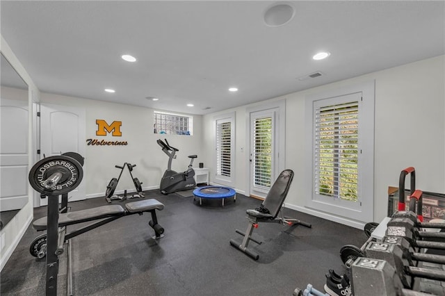 workout area featuring baseboards, visible vents, and recessed lighting