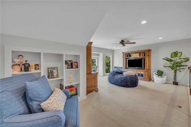 carpeted living area featuring built in shelves, baseboards, a ceiling fan, and recessed lighting