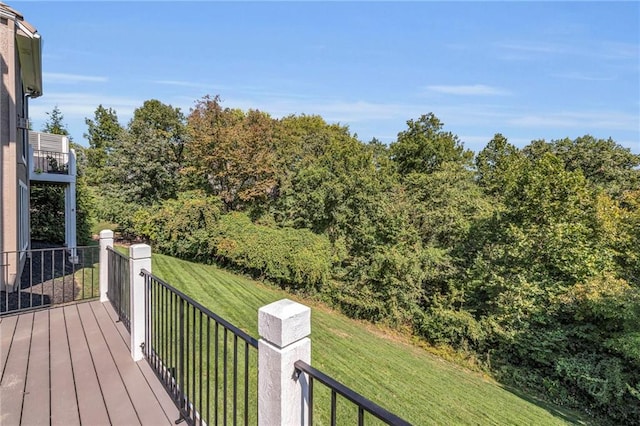 wooden deck featuring a yard