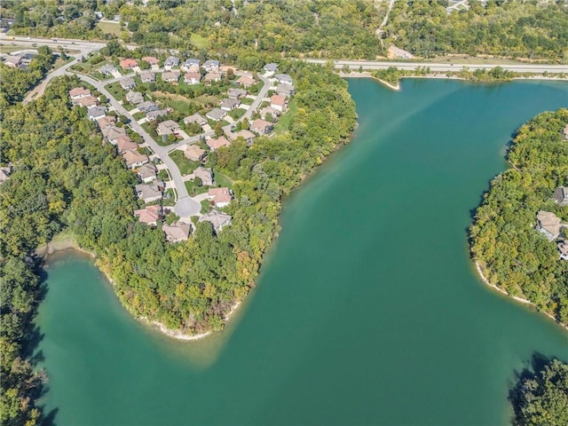 bird's eye view featuring a forest view, a water view, and a residential view