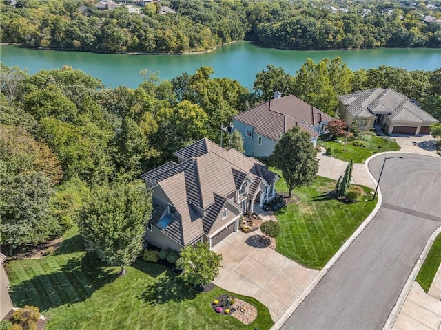 aerial view with a water view and a wooded view