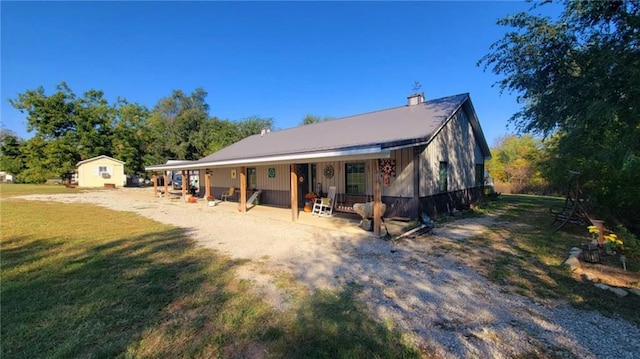 exterior space with a storage shed, a front yard, and an outdoor structure