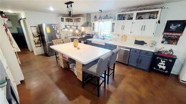 1147 Fern Rd, Fort Scott, KS 66701 - kitchen featuring wall chimney range hood, stainless steel appliances, concrete flooring, a sink, and light countertops