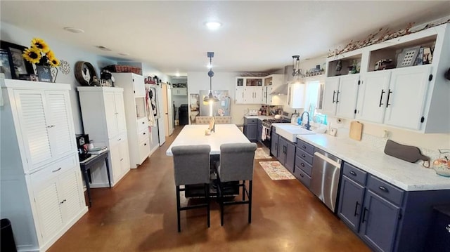 1147 Fern Rd, Fort Scott, KS 66701 - kitchen with appliances with stainless steel finishes, finished concrete flooring, light countertops, decorative light fixtures, and white cabinetry