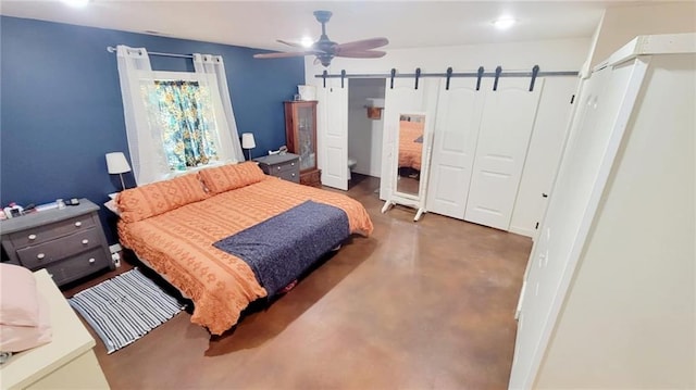 1147 Fern Rd, Fort Scott, KS 66701 - bedroom featuring a barn door, concrete flooring, and a ceiling fan