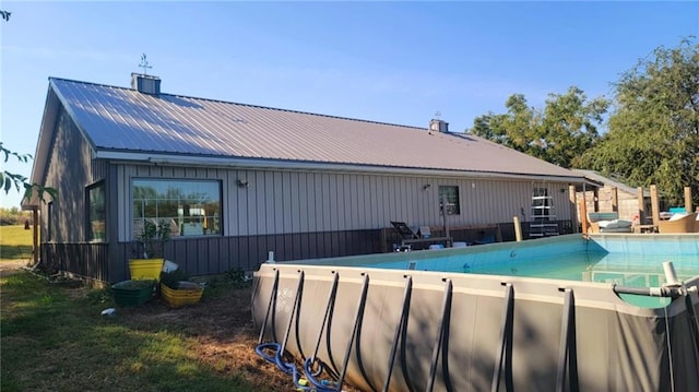 1147 Fern Rd, Fort Scott, KS 66701 - rear view of property featuring a chimney, metal roof, and board and batten siding