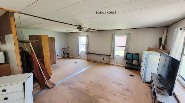 1147 Fern Rd, Fort Scott, KS 66701 - unfurnished living room with a ceiling fan and baseboards