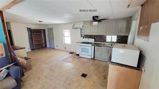 1147 Fern Rd, Fort Scott, KS 66701 - kitchen featuring white appliances, ceiling fan, decorative backsplash, a sink, and light floors