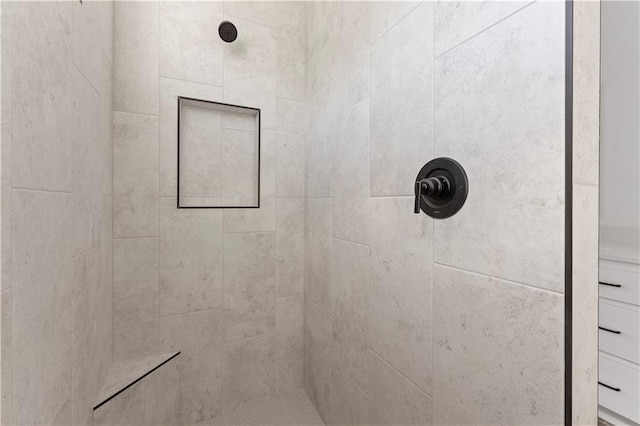 full bath with a tile shower