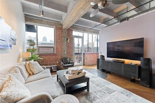 living room featuring visible vents, brick wall, beamed ceiling, and a ceiling fan