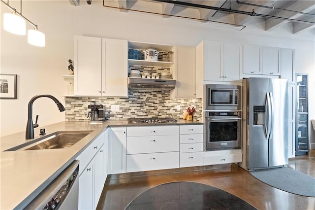 kitchen with a sink, white cabinets, appliances with stainless steel finishes, backsplash, and open shelves