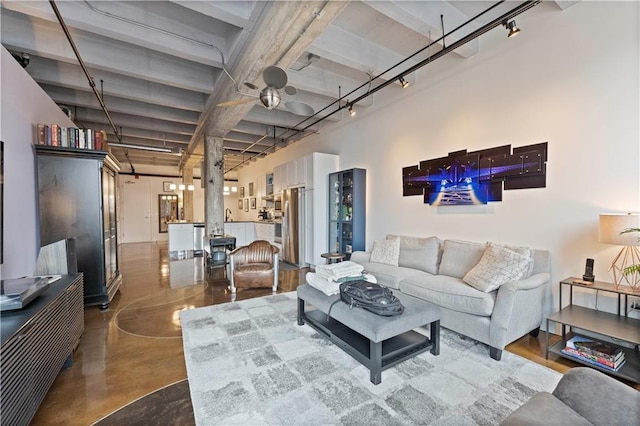 living room featuring rail lighting and concrete flooring