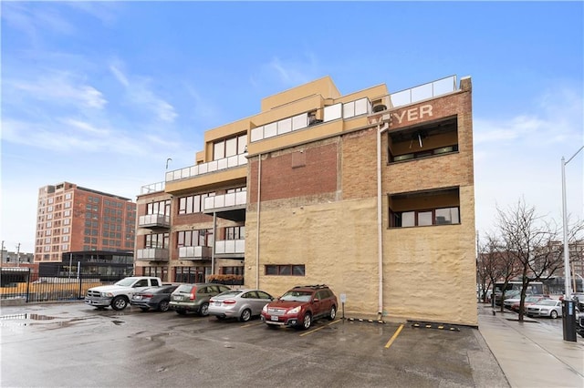 view of building exterior featuring uncovered parking