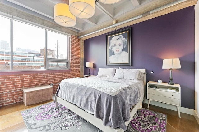 bedroom with a view of city, baseboards, brick wall, and tile patterned floors