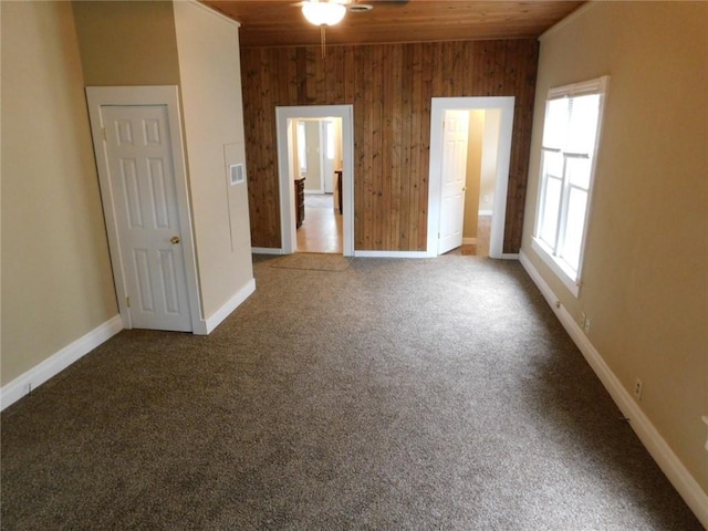 306 W Kansas St, Pittsburg, KS 66762 - interior space featuring carpet floors, wood walls, multiple windows, and wood ceiling