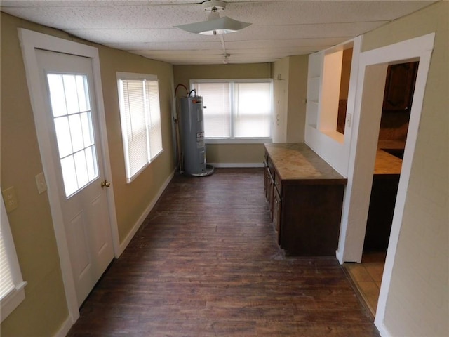 306 W Kansas St, Pittsburg, KS 66762 - hallway featuring a paneled ceiling, water heater, dark wood finished floors, and baseboards