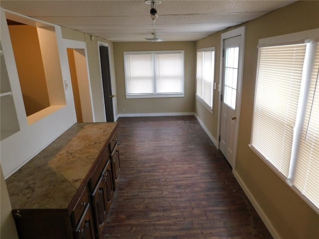306 W Kansas St, Pittsburg, KS 66762 - interior space featuring dark wood-type flooring and baseboards