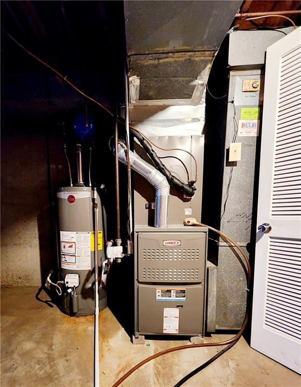 utility room featuring gas water heater