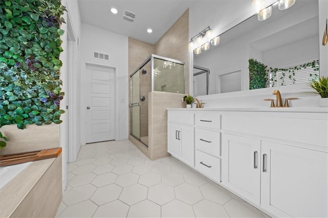 full bath with recessed lighting, a sink, visible vents, a shower stall, and double vanity