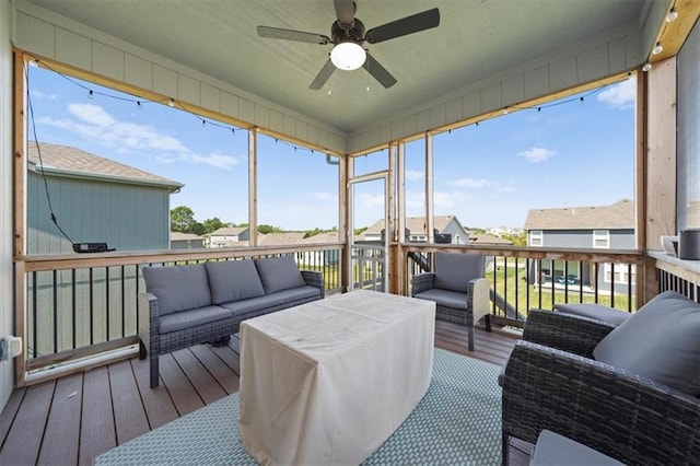 sunroom / solarium with a ceiling fan and a wealth of natural light