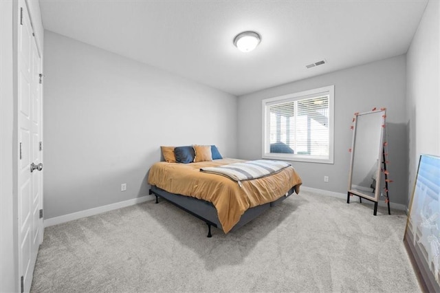 carpeted bedroom featuring visible vents and baseboards