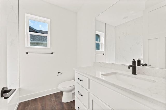 full bathroom featuring baseboards, vanity, toilet, and wood finished floors