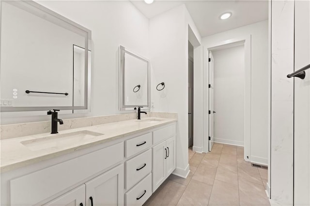 full bathroom featuring double vanity, visible vents, a sink, and recessed lighting