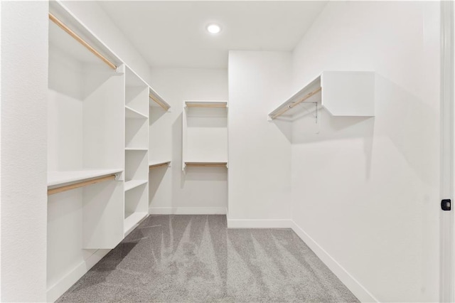 spacious closet with carpet and attic access