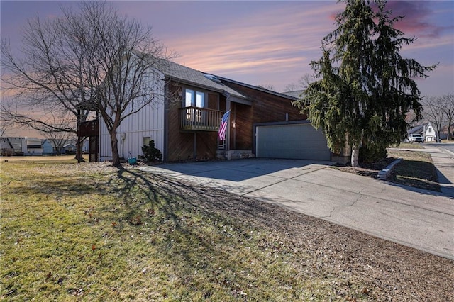 view of front of home with a garage, driveway, and a front lawn