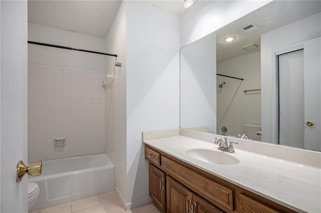 bathroom with tile patterned flooring, visible vents, vanity, and toilet