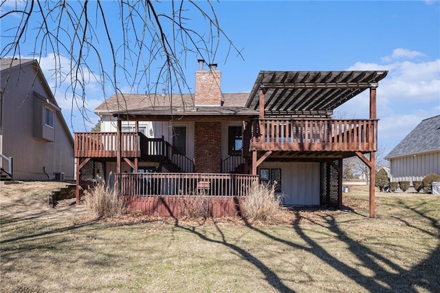 rear view of property with a deck, stairway, and a chimney