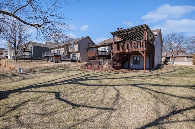 rear view of house with a residential view, a lawn, and a wooden deck