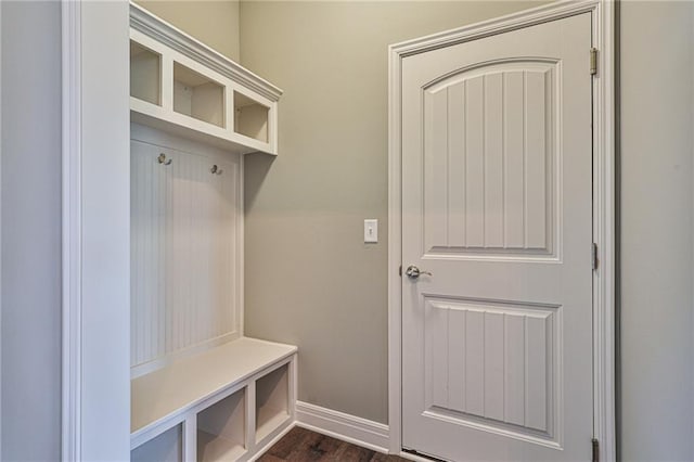 mudroom with dark wood-style floors and baseboards