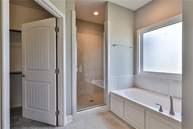 full bath featuring a stall shower, recessed lighting, a bath, and tile patterned floors