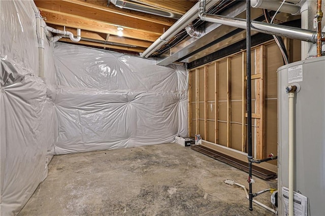 unfinished basement featuring gas water heater