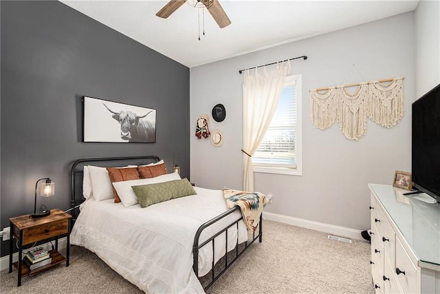 bedroom featuring baseboards, light carpet, visible vents, and a ceiling fan