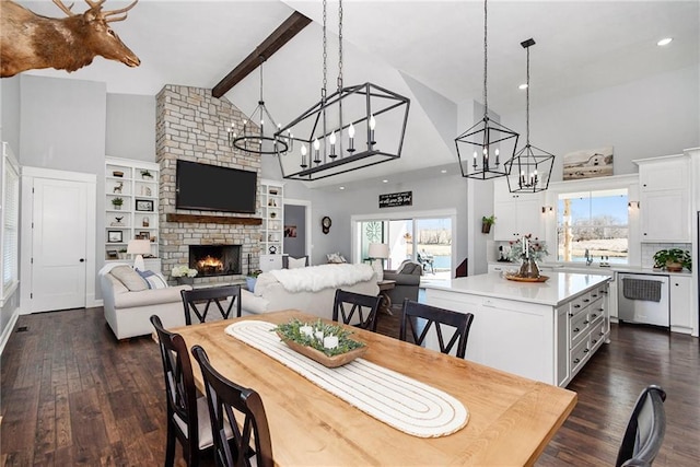 dining area featuring beamed ceiling, high vaulted ceiling, a notable chandelier, dark wood-style floors, and a fireplace