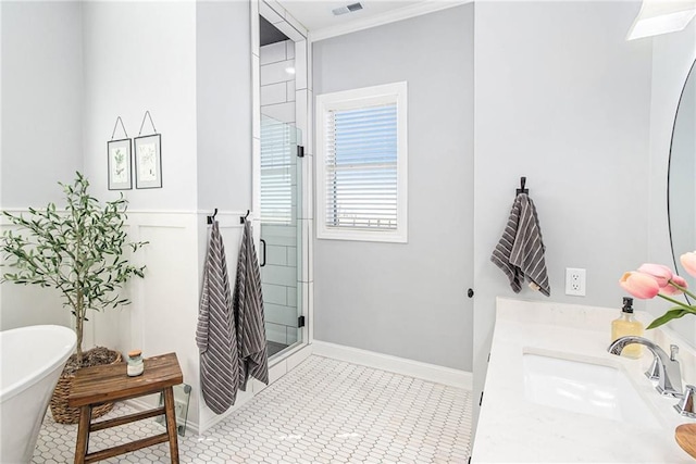 bathroom featuring vanity, baseboards, a freestanding tub, a shower stall, and tile patterned floors