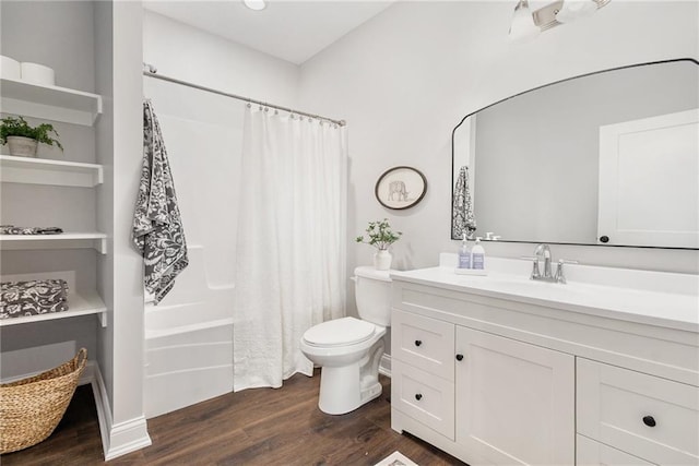 bathroom with vanity, toilet, wood finished floors, and shower / bath combo