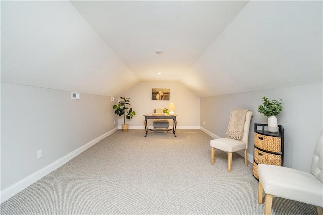 living area featuring visible vents, baseboards, light colored carpet, and lofted ceiling