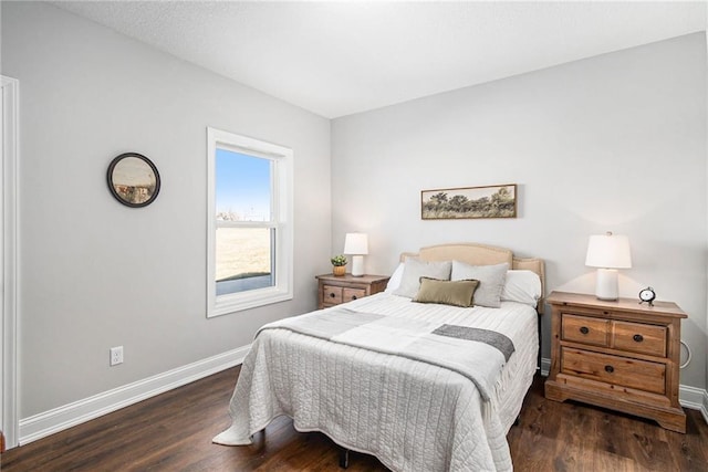 bedroom featuring baseboards and wood finished floors